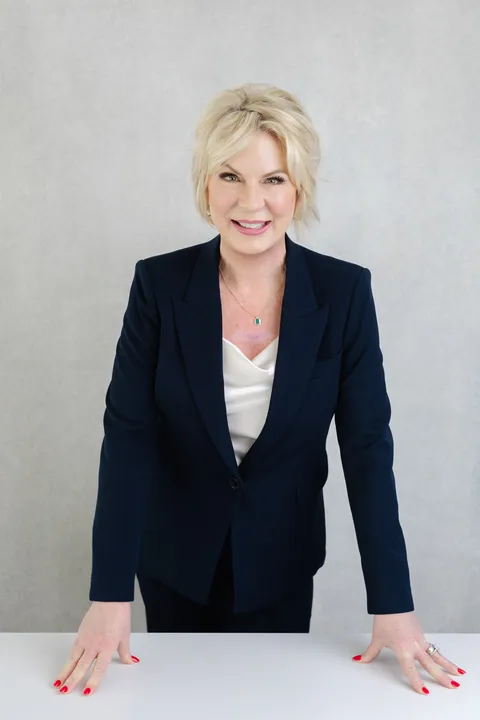 Boise brand photographer — confident female founder in navy suit on white, J Renee Studios